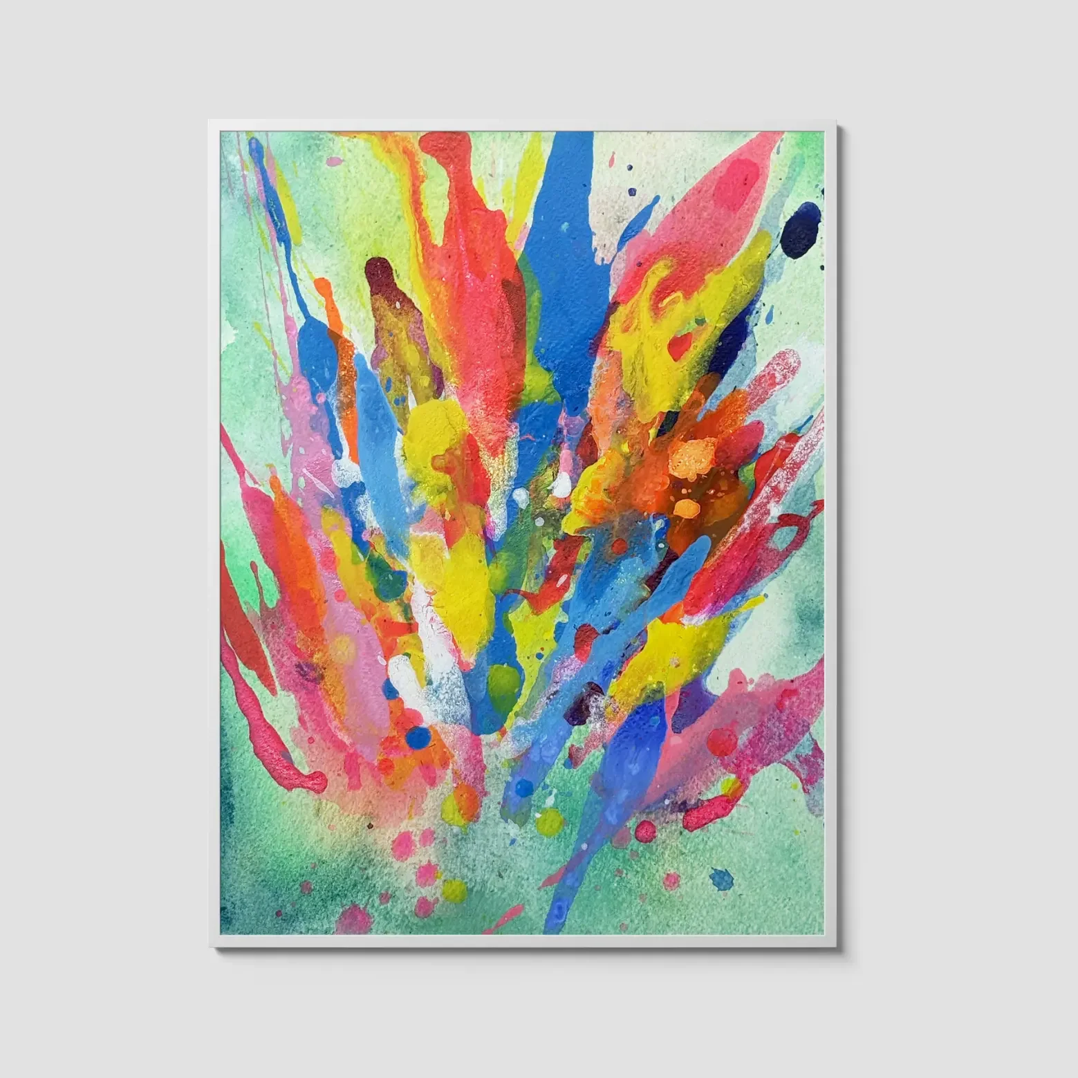 Colorful abstract watercolor painting featuring vibrant splashes of pink, blue, yellow, orange, and red bursting upward against a soft mint green background, displayed in a white frame.