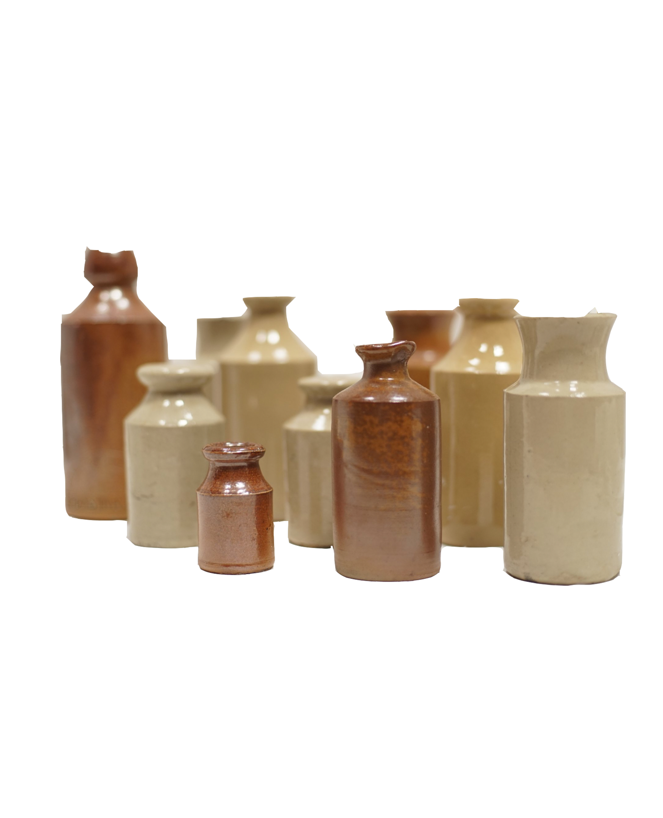 Various ceramic vases of different sizes and colors arranged on a surface.