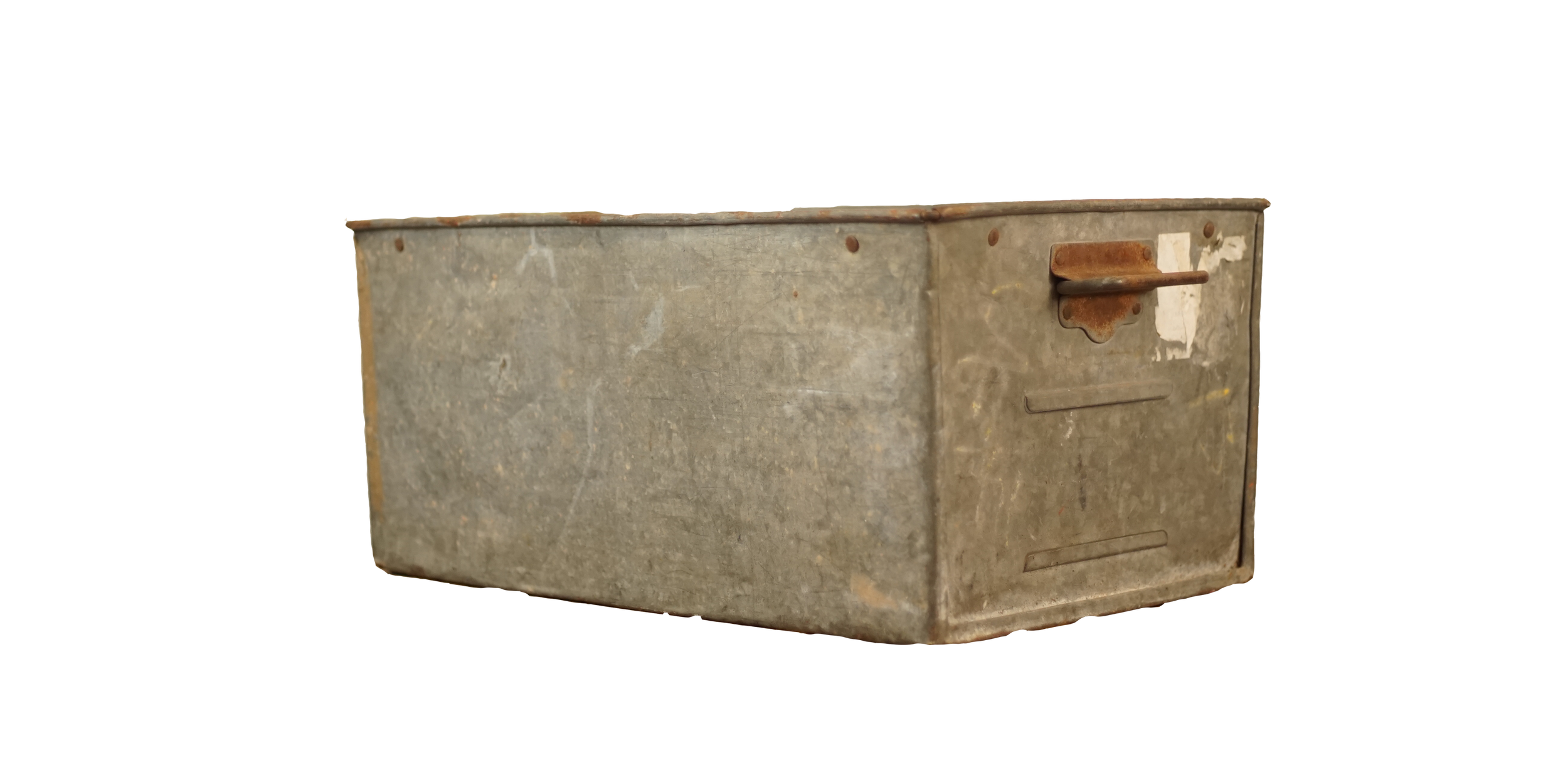 Old, rusted metal container with a handle on the front and worn white paint patches on the surface.