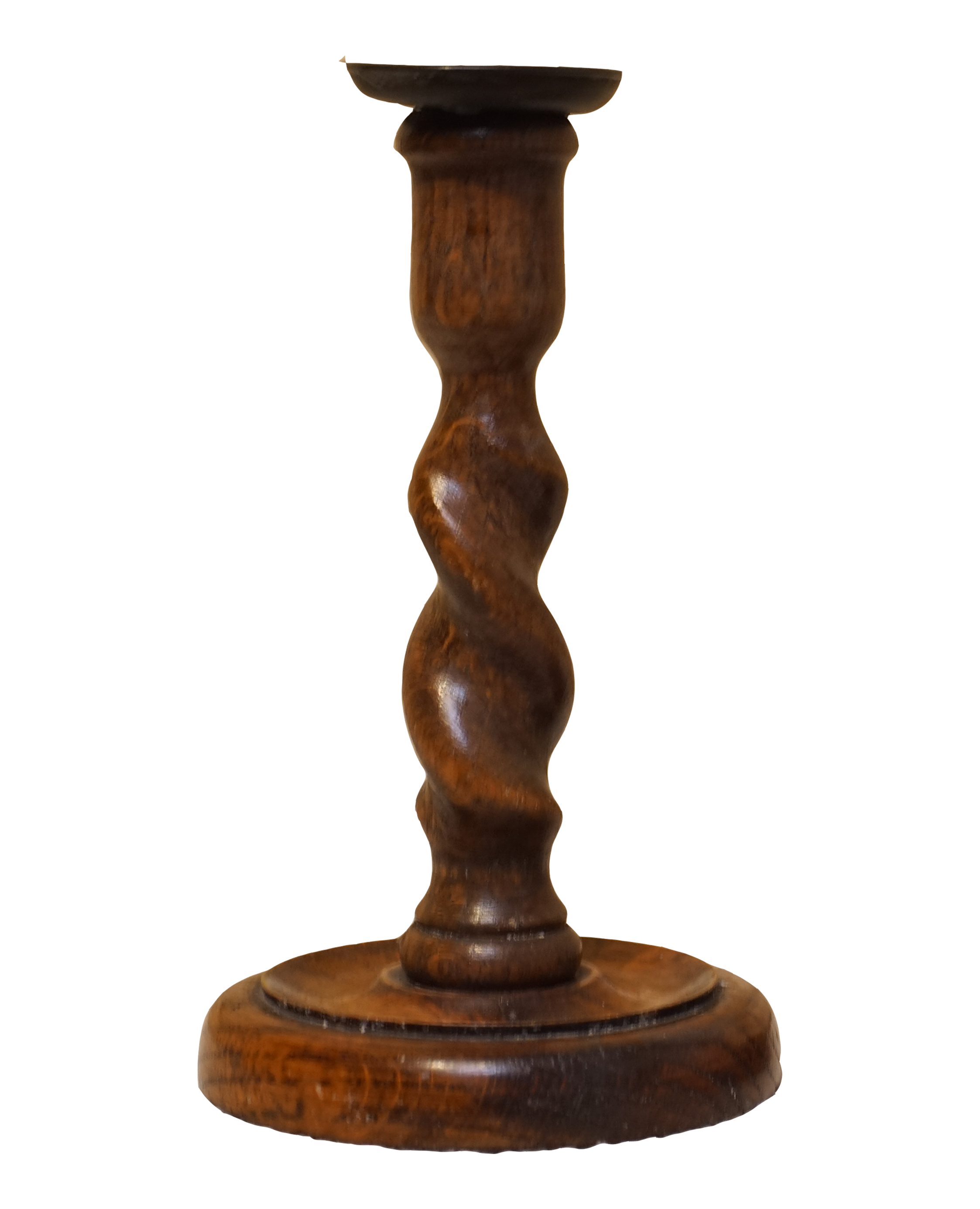 Close-up of a wooden candlestick holder with a turned, twisted design.