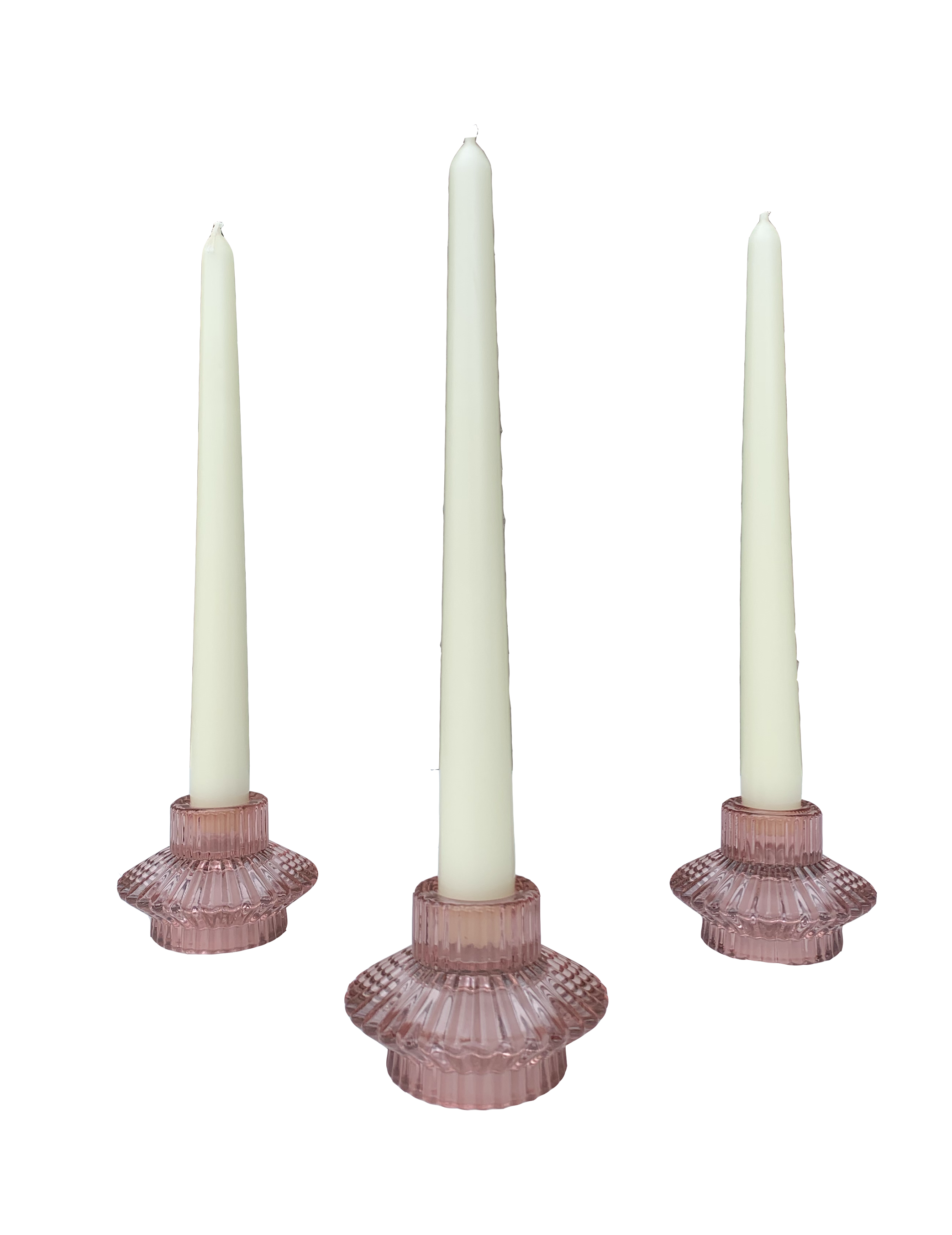 Three pink glass candle holders with tall white candles on a black background.