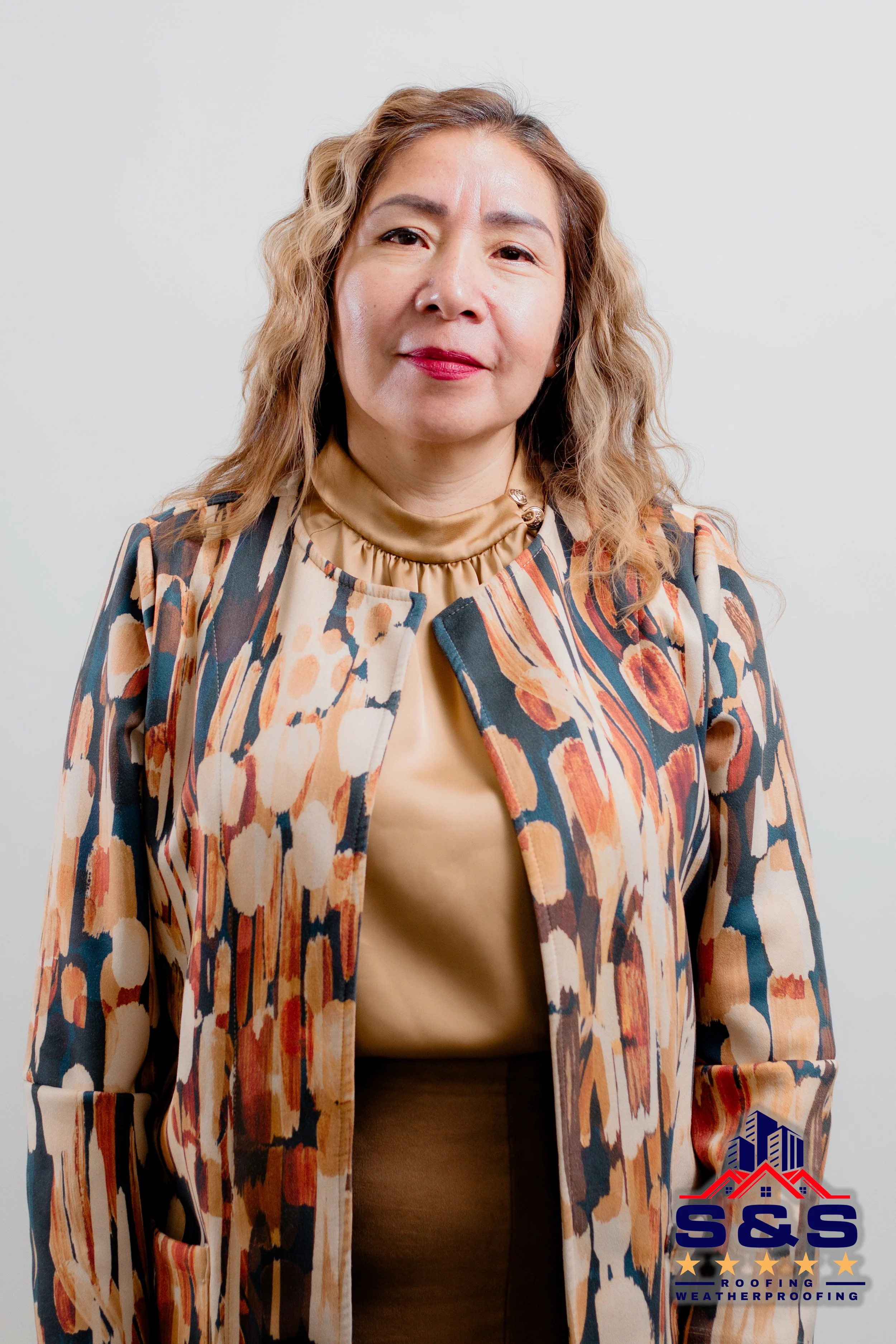 Smiling woman in white dress shaking hands outdoors