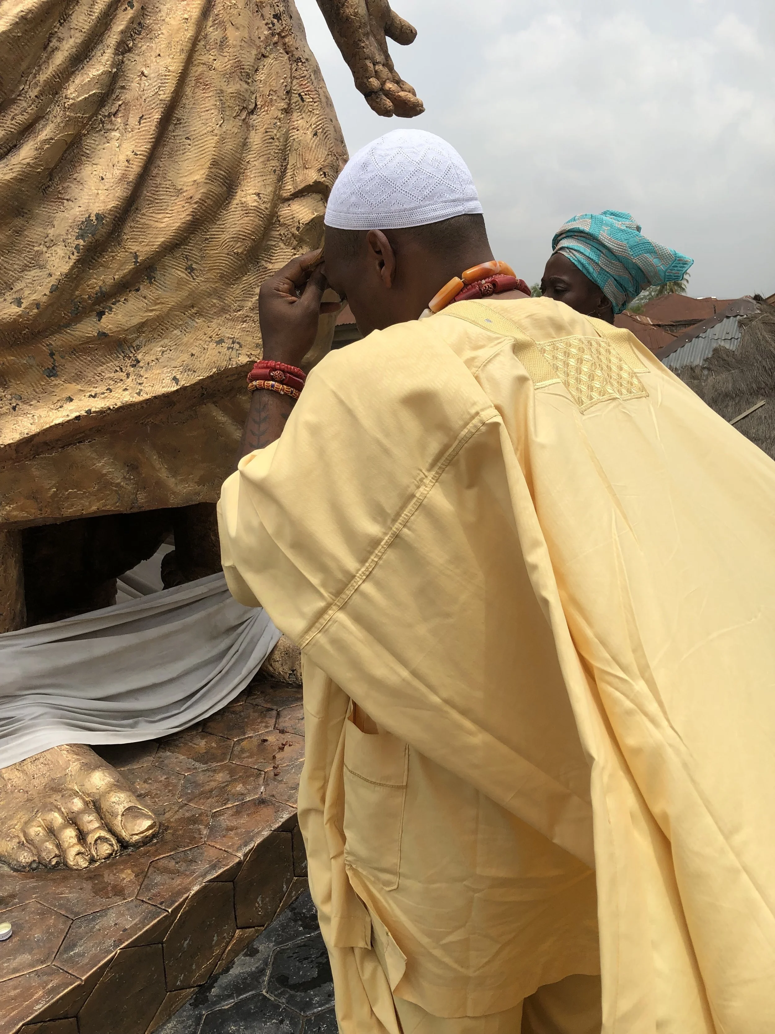 At the sacred shrine of Moremi Àjàṣorò in Ilé-Ifẹ̀—the spiritual source and ancestral homeland of the Yoruba people—offering prayers at the direction of His Imperial Majesty, the Ọọ̀ni of Ifẹ̀.