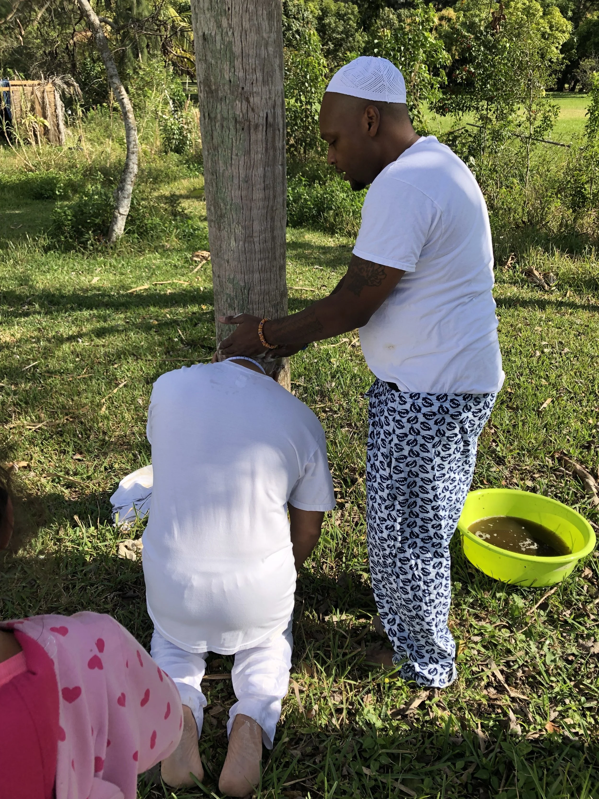 Performing the traditional Ìborí (head-washing) ceremony during an Olókun initiation at my temple compound.