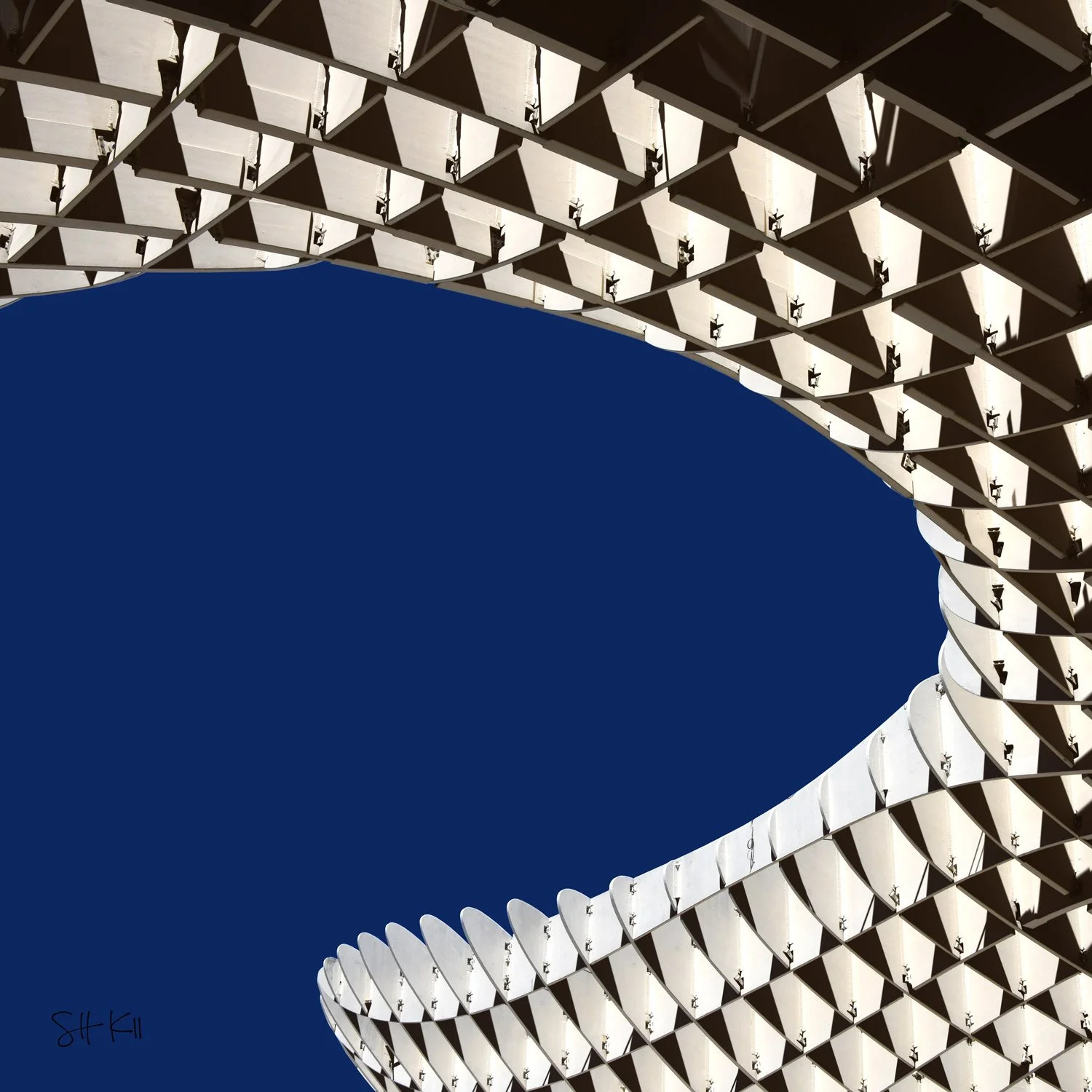 Curved white lattice canopy with diamond panels against deep blue sky — Metropol Parasol Seville photograph