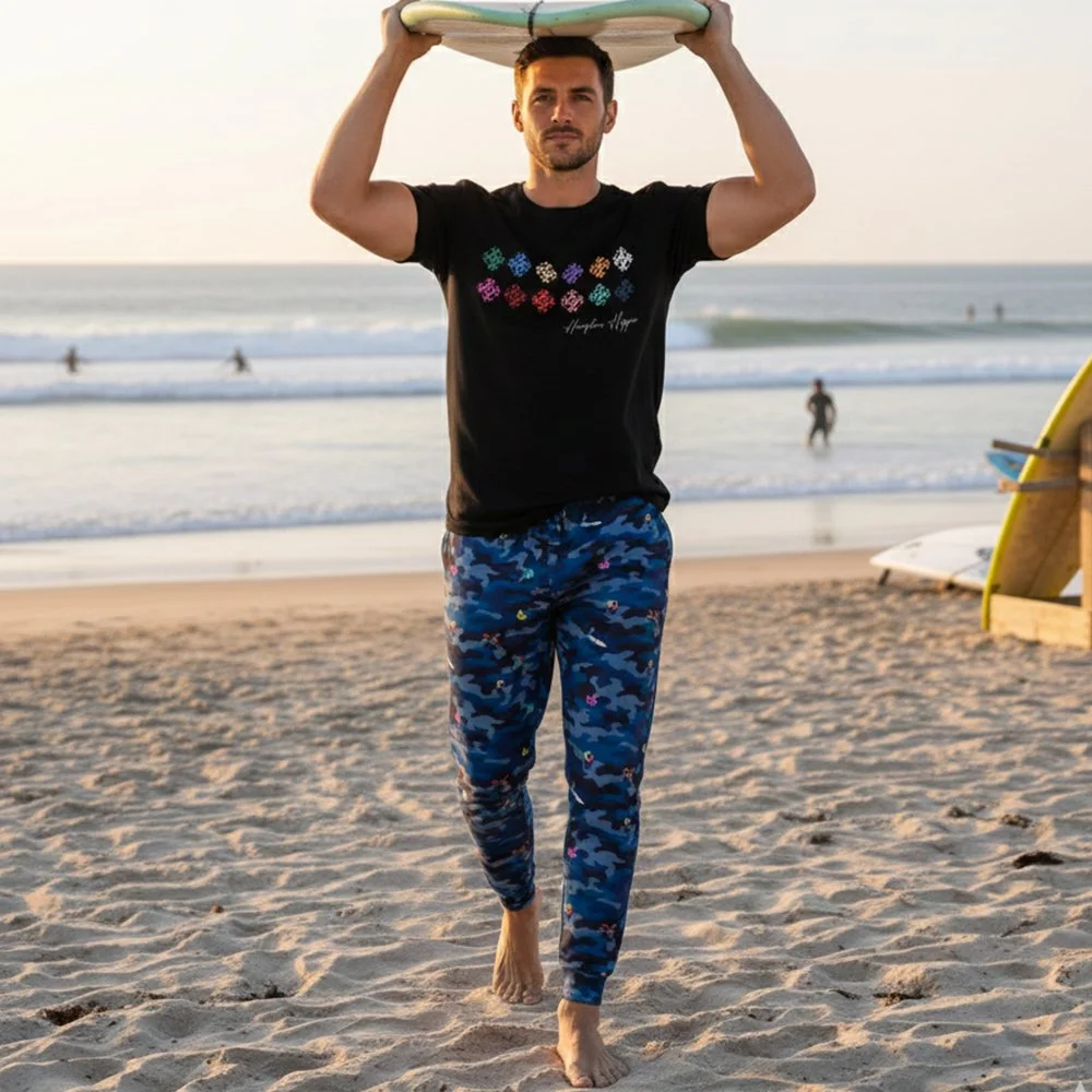 Man carrying surfboard on his head. HH Sea Camo Men’s Joggers