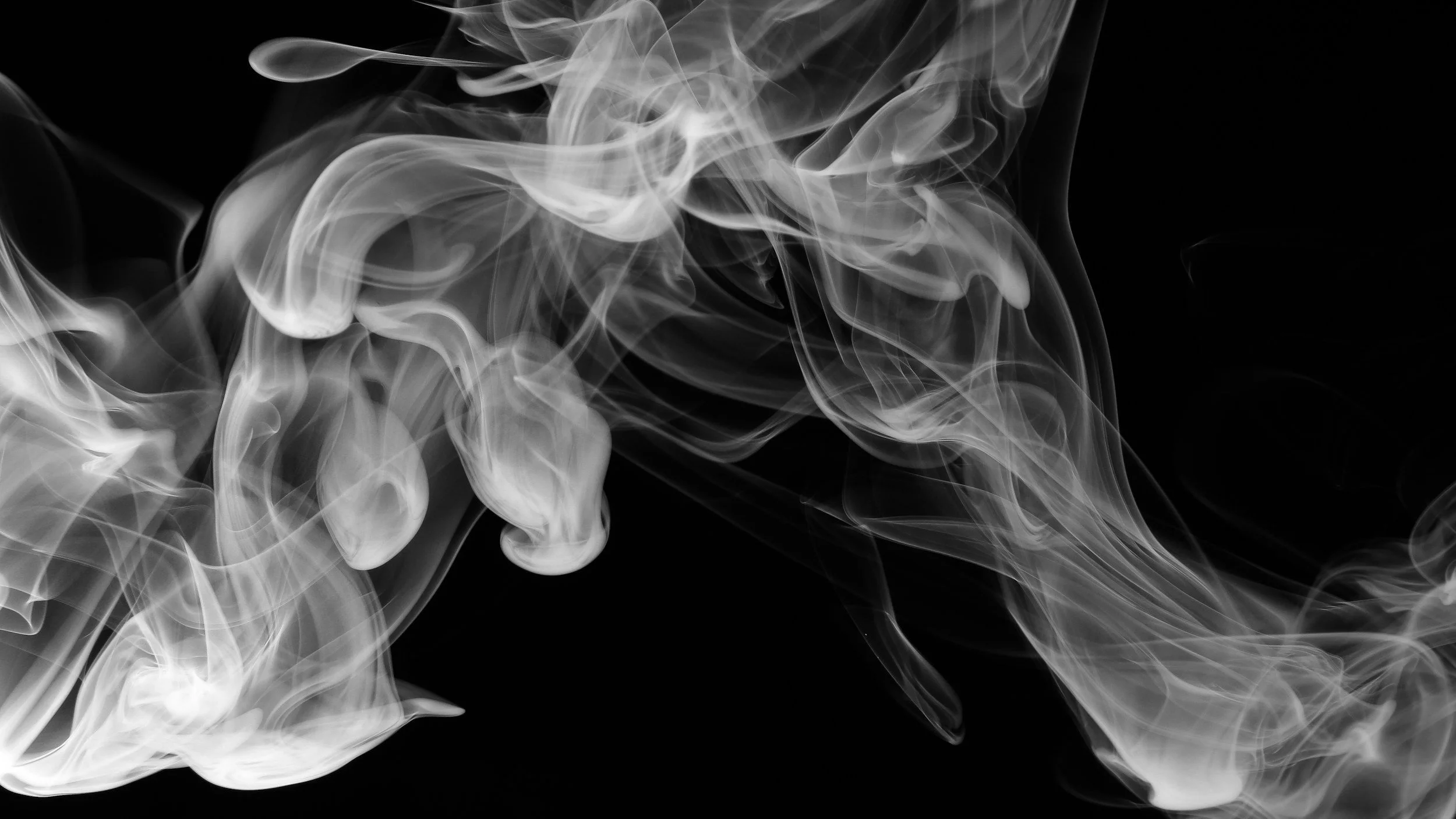 a black and white photo of smoke