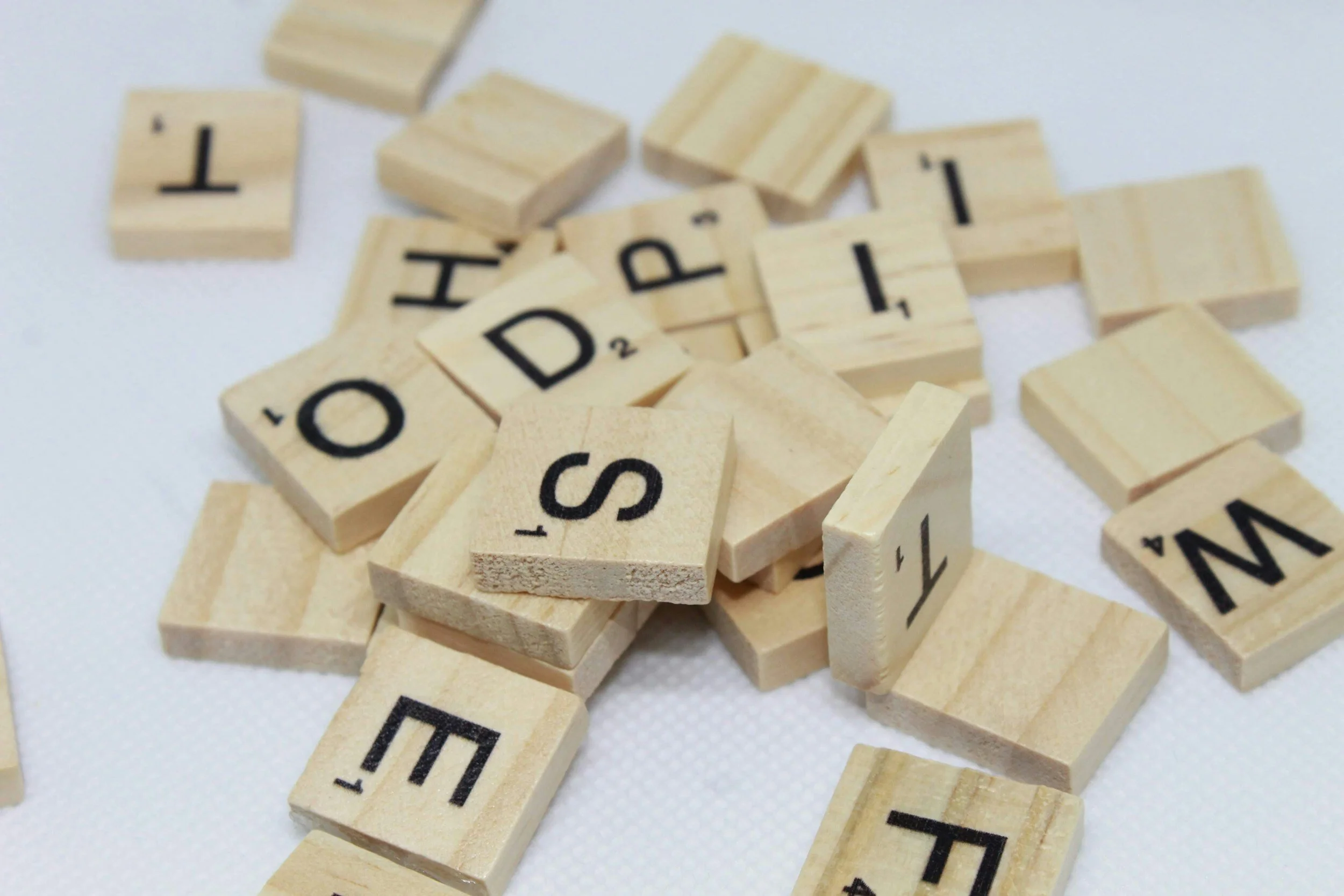 Spelling game wood pieces with letters on them