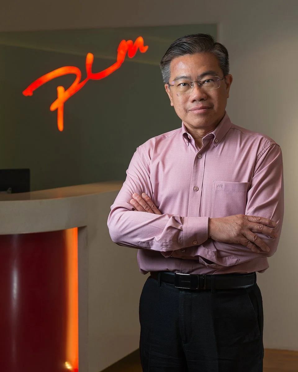 editorial corporate portrait in front of company logo
