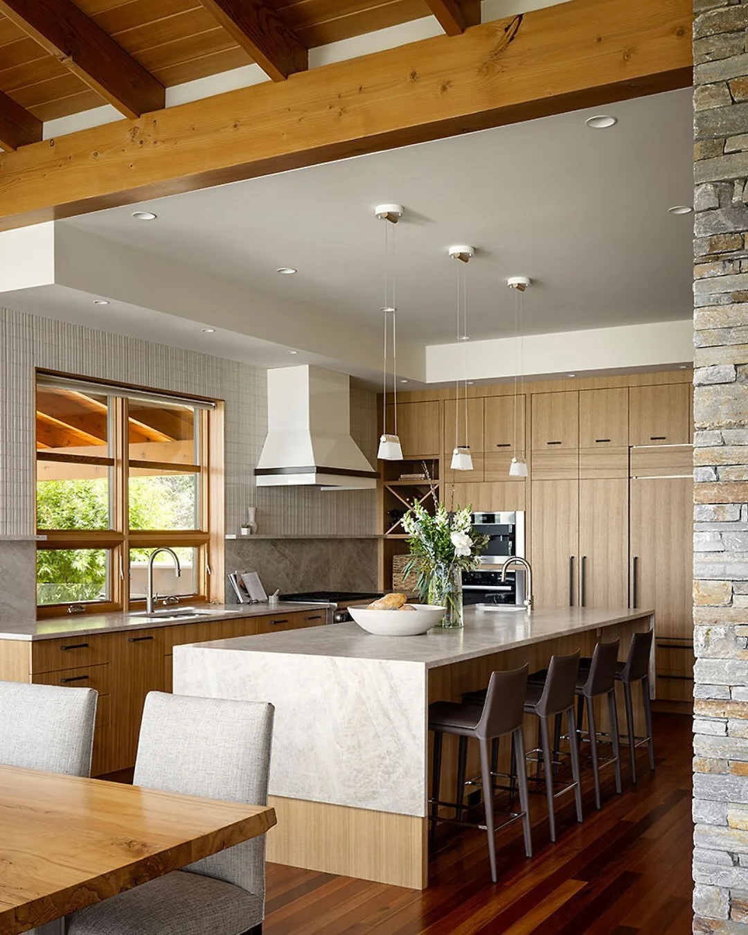 Our Timber Ridge [Invermere] kitchen was a stunning before-and-after! Inspired by the home&rsquo;s lakeside location and architecture, the final design features custom, rift-cut white oak cabinetry, leathered Taj Mahal counters, and dimensional ivory