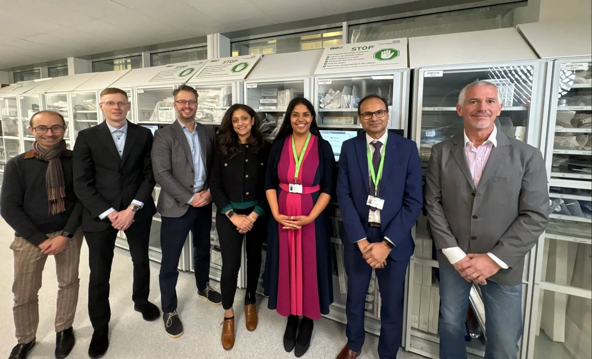 Representatives from KFM and Omnicell standing in a hospital inventory management area in front of medical supply storage cabinets. The image highlights healthcare supply chain management and optimisation to support patient care.