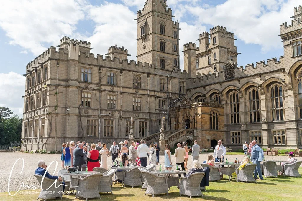 Guests enjoying wedding reception on lawn at Carlton Towers