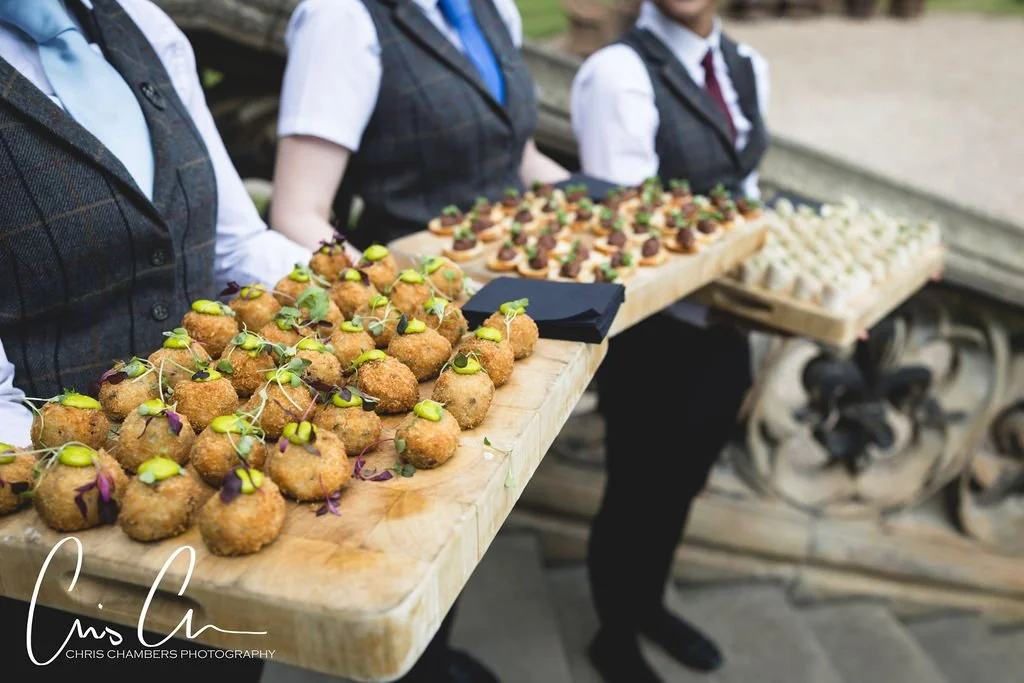 Front of House staff carrying trays of canapes at Carlton Towers Wedding