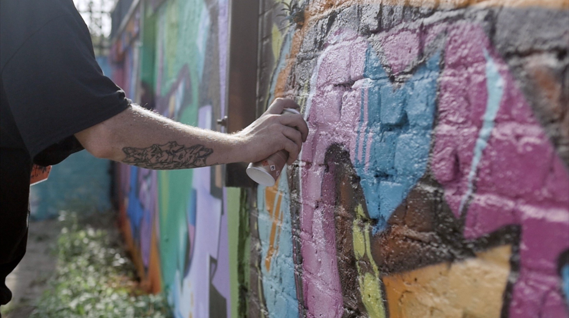 Nomadic Community Gardens documentary close up spray can wall paint.jpg