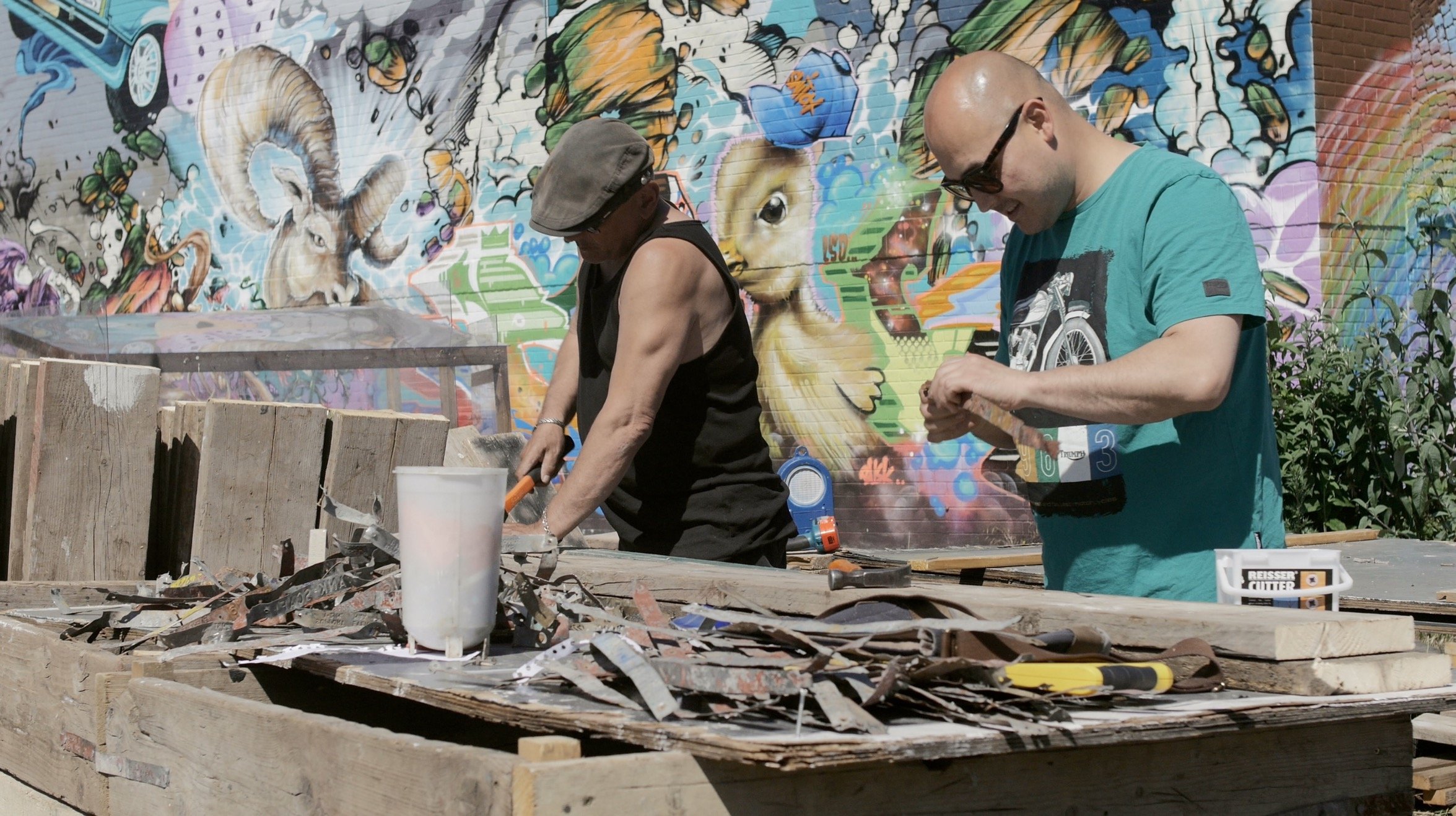 Nomadic Community Gardens documentary men working hammers.jpg