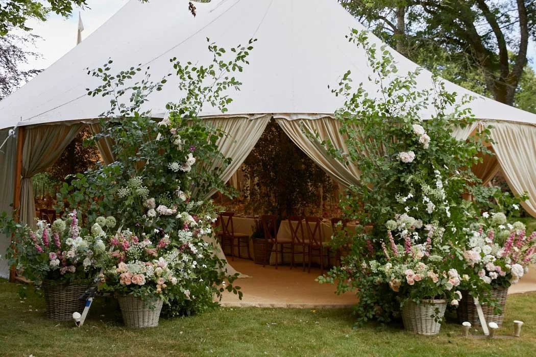 Wedding flowers at entrance of marquee near Stroud