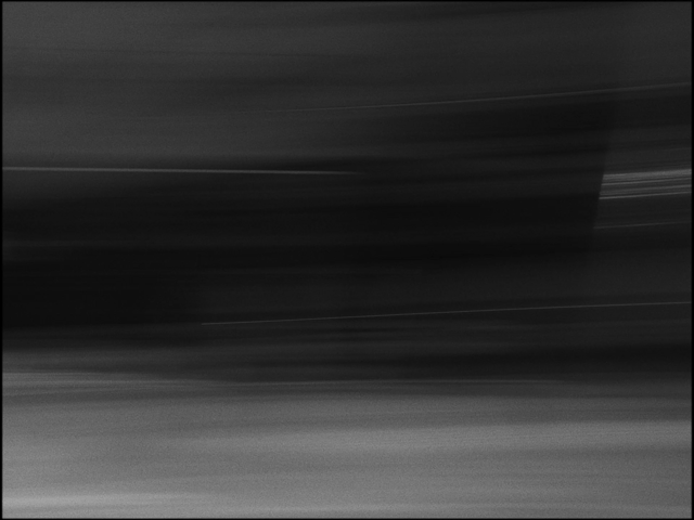 Blurred black and white abstract image with horizontal streaks.