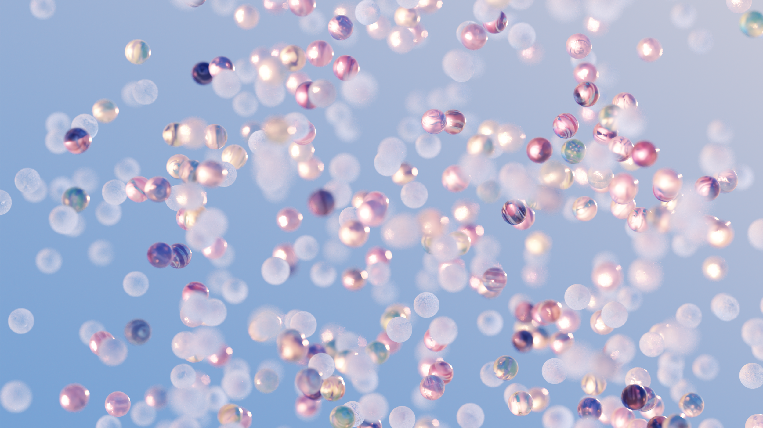 Colorful translucent spheres floating against a blue background.