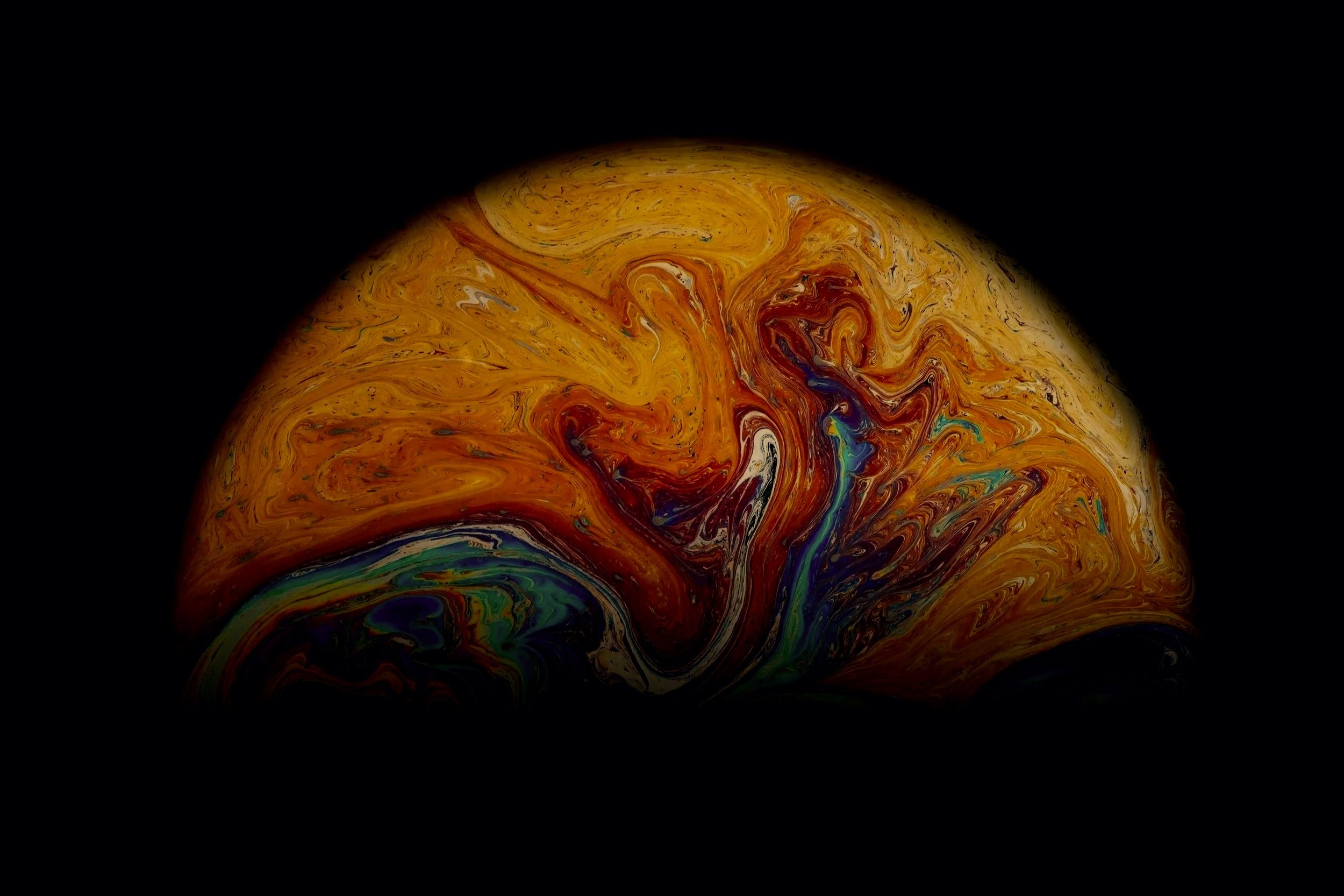 Swirling, colorful abstract pattern resembling a planet or galaxy against a black background. Astrology and reiki healing in Chichester, Bognor Regis, West Sussex, Portsmouth, Midhurst.