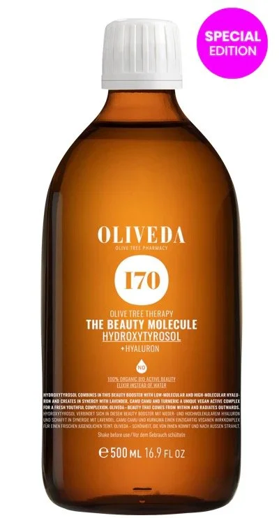 Amber-colored bottle of Oliveda beauty molecule hydroxytrosol with a white cap, label indicating special edition, 500ml, 16.9 fl oz.