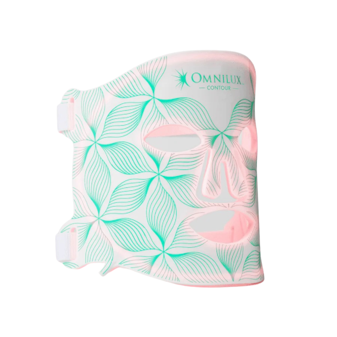 A white face mask with teal leaf patterns and cutouts for eyes, nose, and mouth, labeled 'Omnilux Contour'.