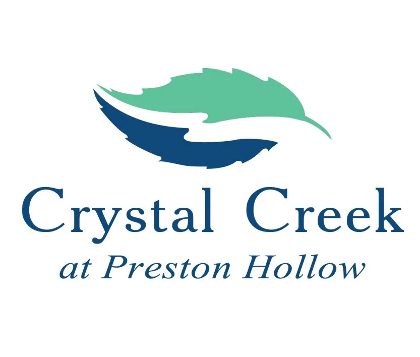 Logo for Crystal Creek at Preston Hollow featuring stylized green and blue feathers above the text.