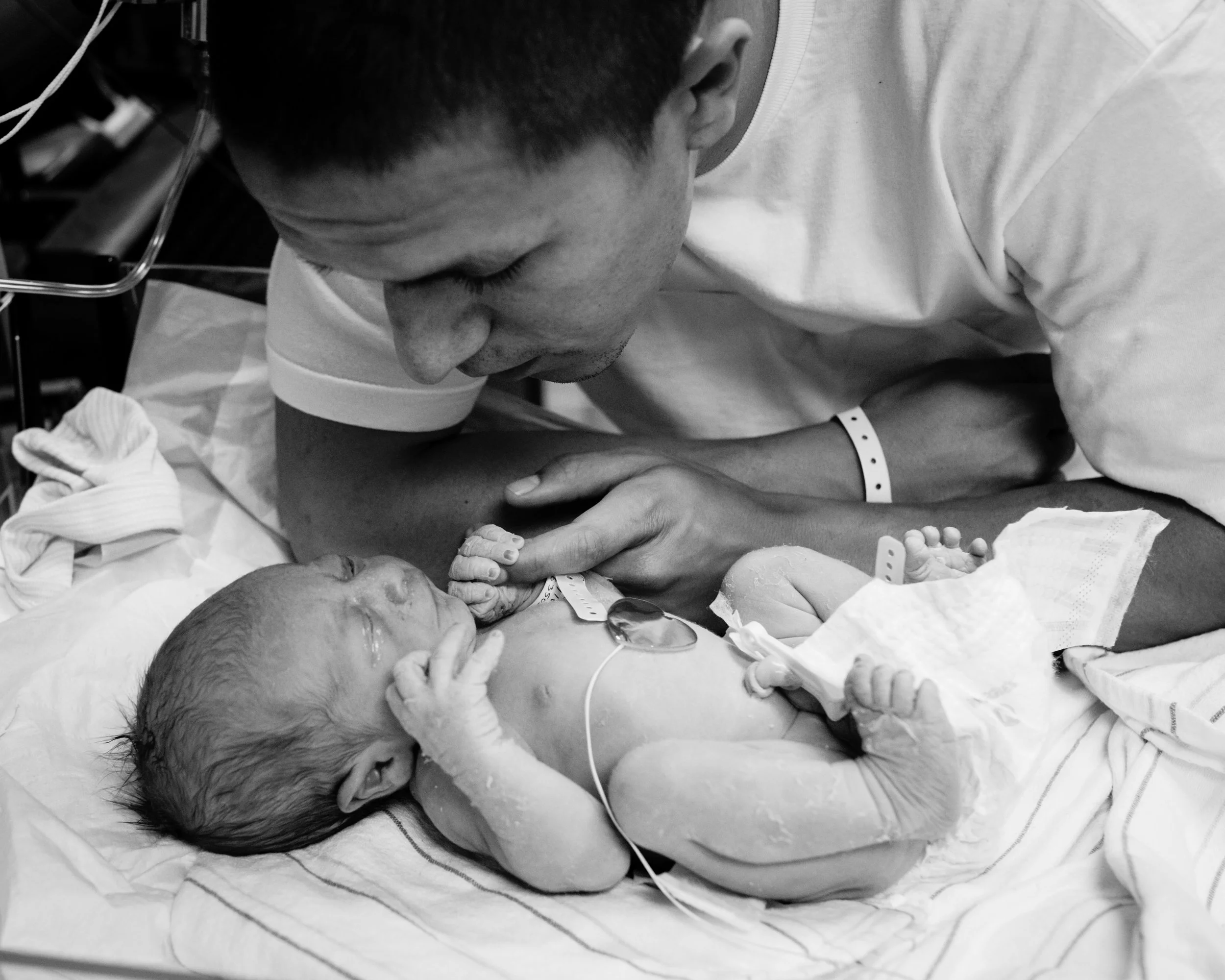 newborn baby grabs on to dad's hand after birth, hospital birth, ventura birth photography