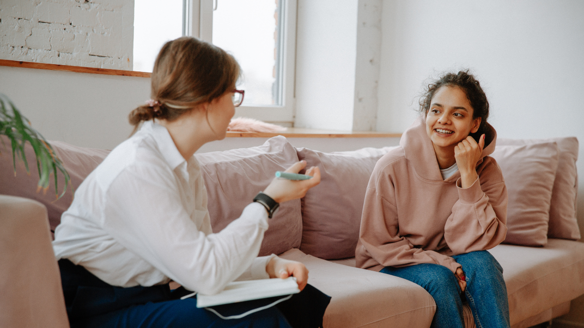 Therapist and client talking together during an individual therapy session.