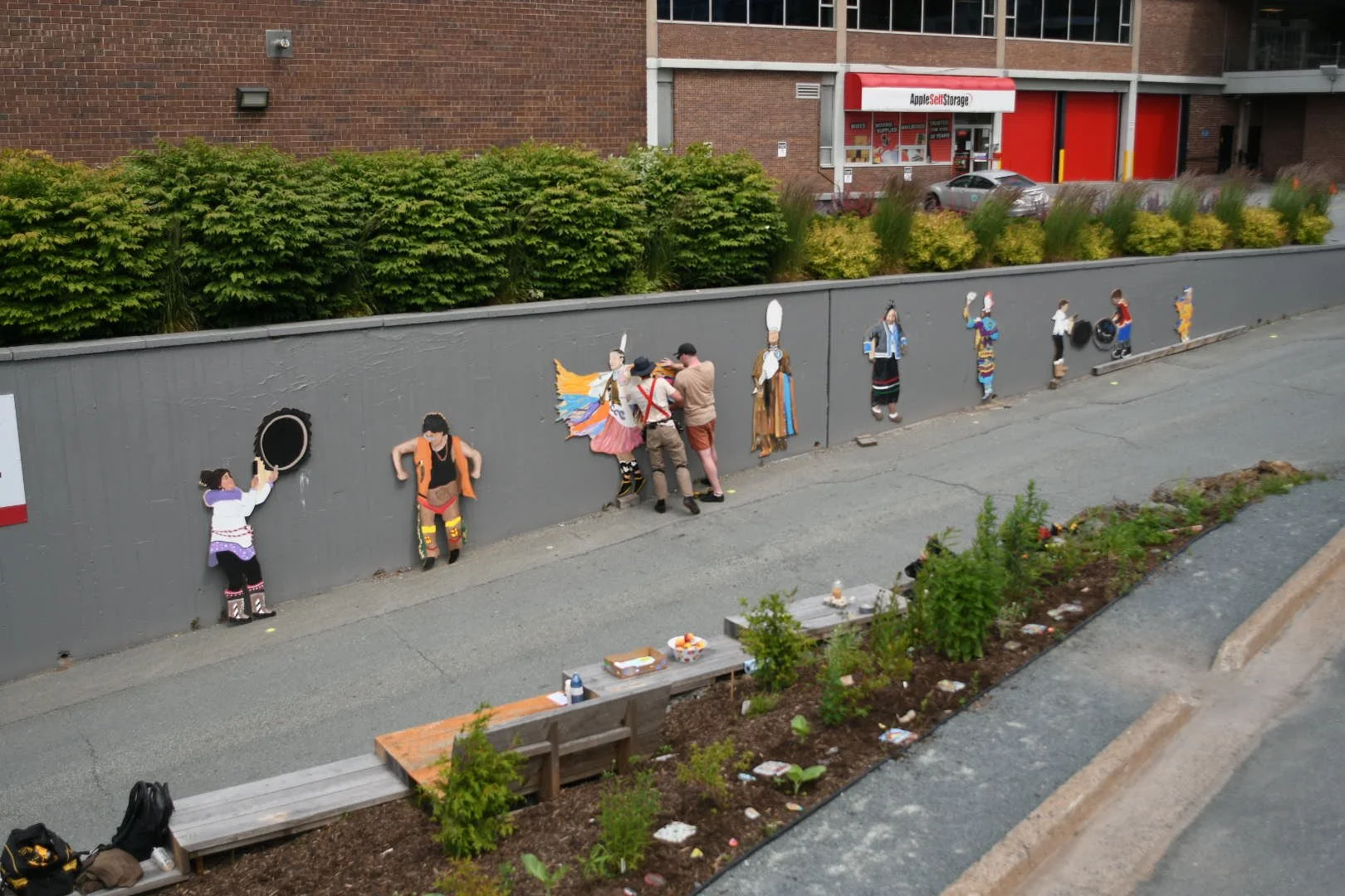 Installing the Powwow Dancer mural at the Mi'kmaw Native Friendship Centre. 