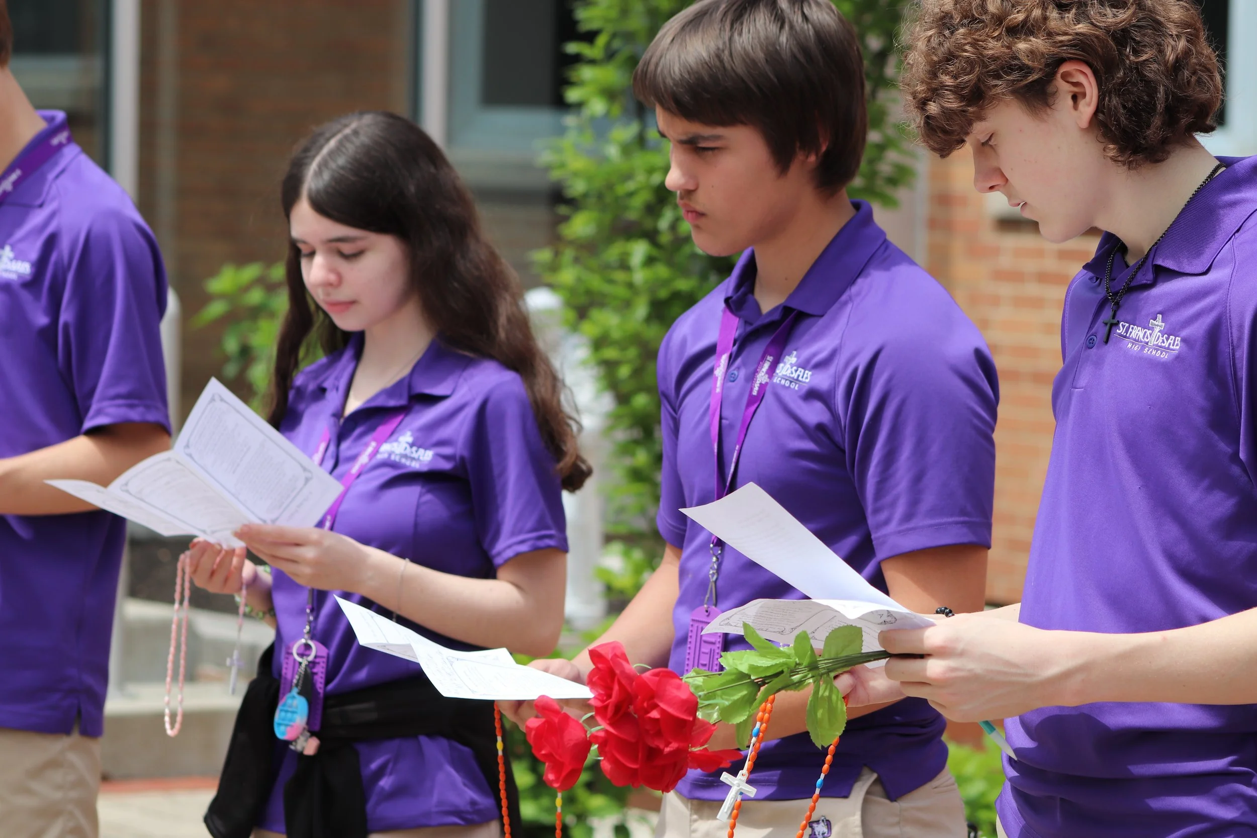 Students praying the rosary in a theology class at St. Francis DeSales High School