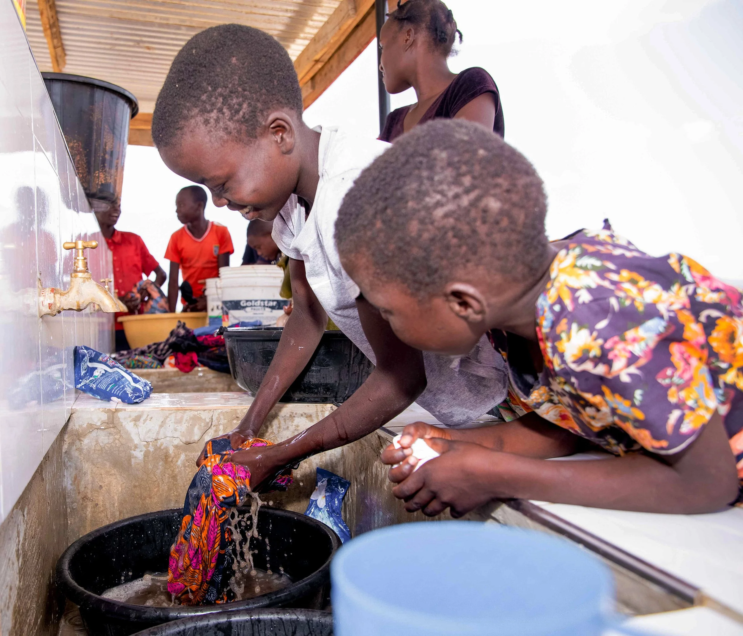 Children washing clothes.