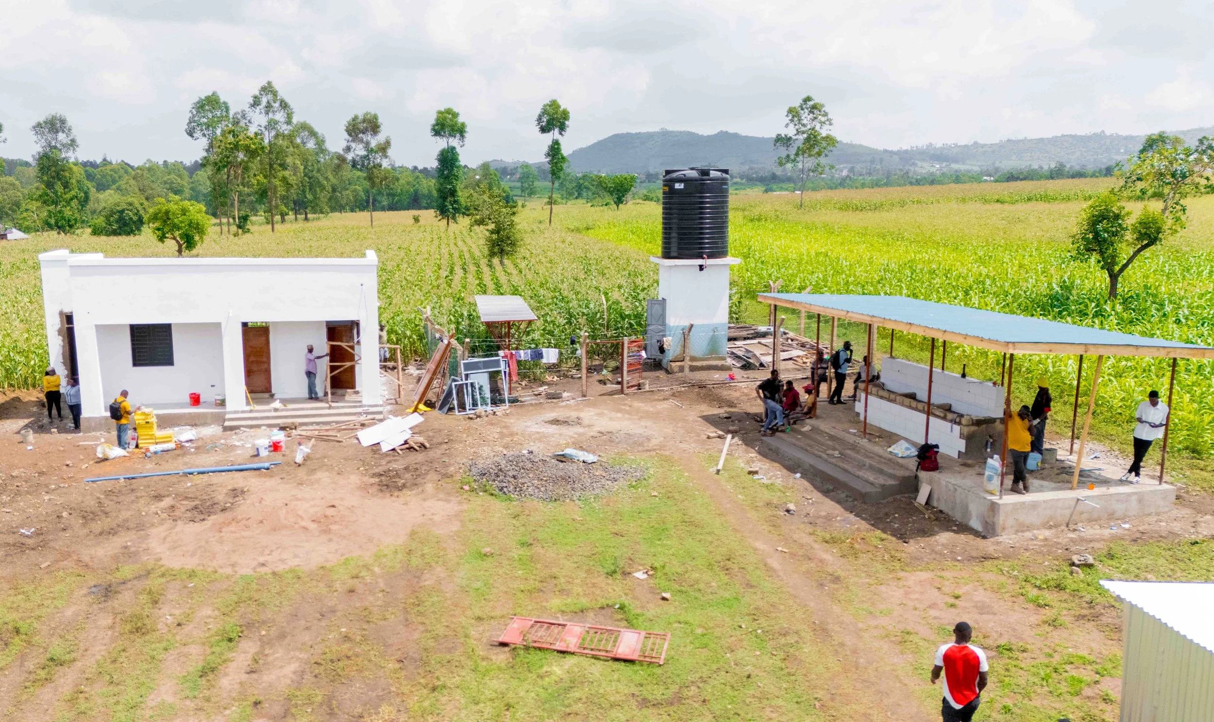 WASH Hub No.2 with green fields and trees in the background.