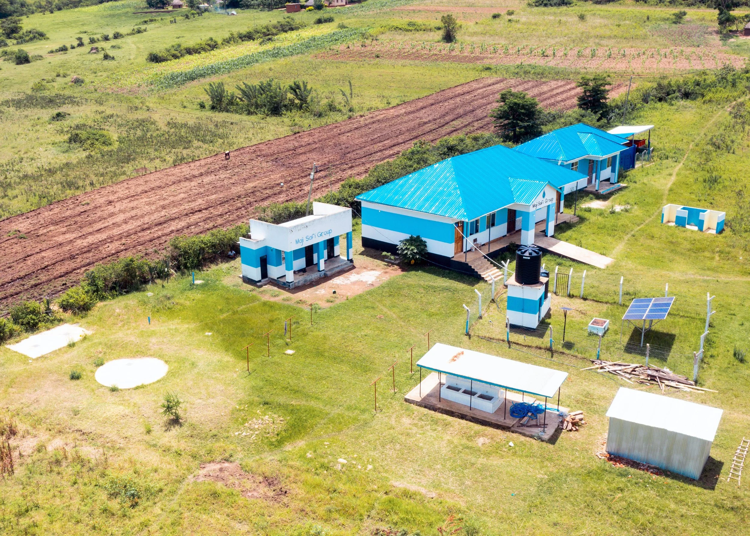 Aerial view of a WASH Hub buildings and water sources..