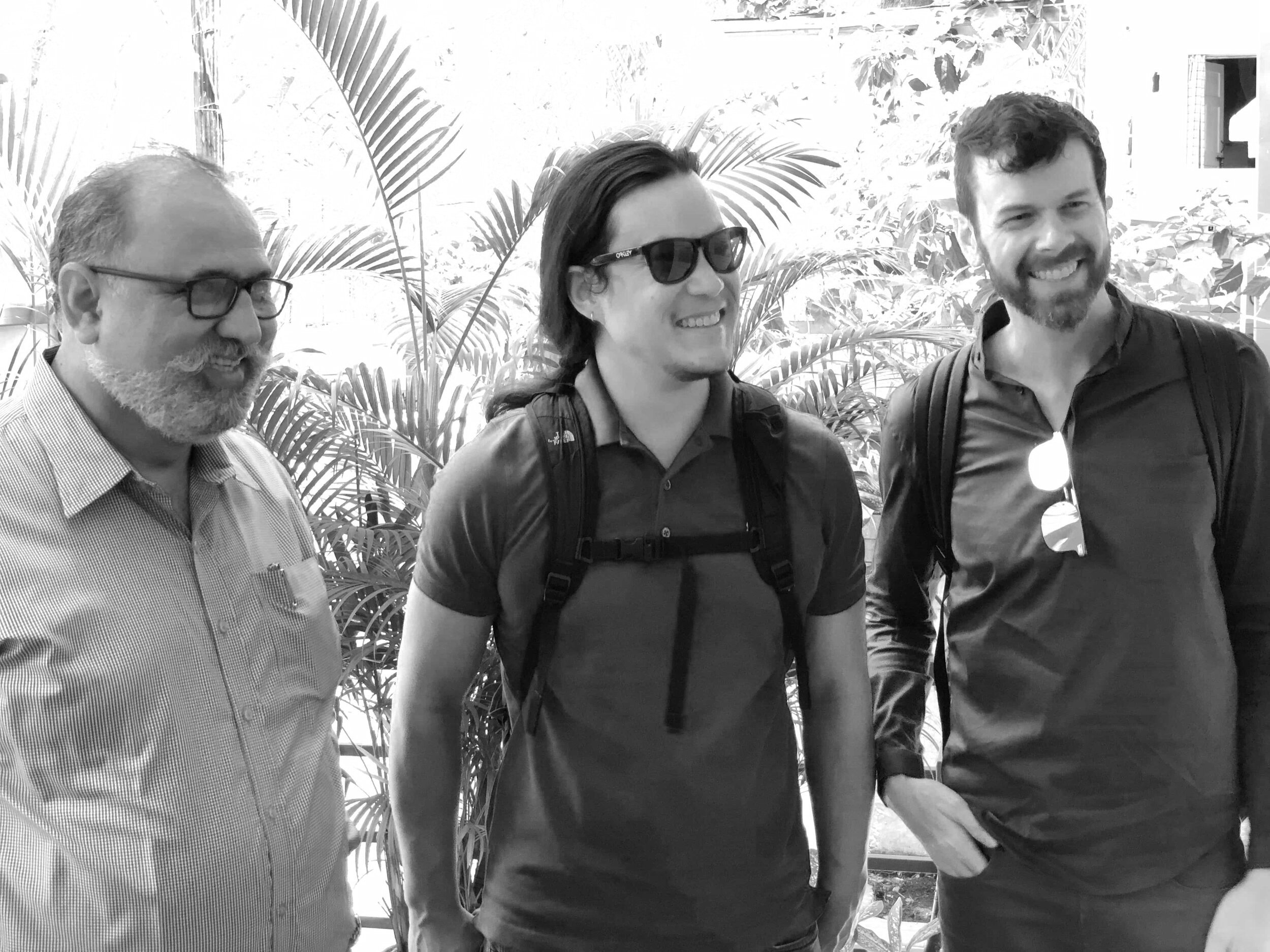 multicultural men in smiling tropical setting