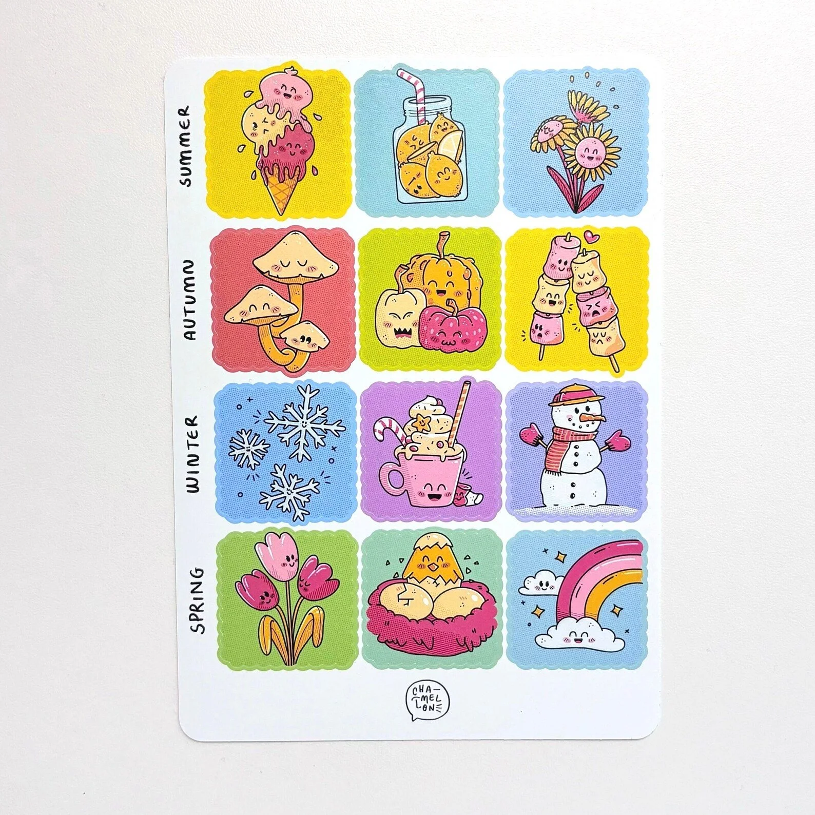 Sheet of illustrated seasonal stickers organized by summer, autumn, winter, and spring, including ice cream, mushrooms, snowflakes, and flowers
