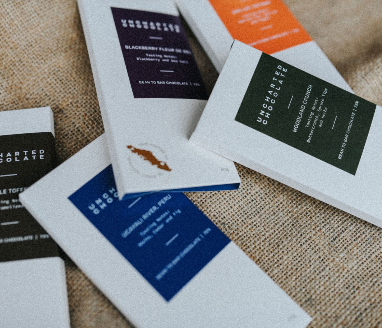 An assortment of embossed chocolate packages for Uncharted Chocolate, Vancouver Island-based chocolatiers.