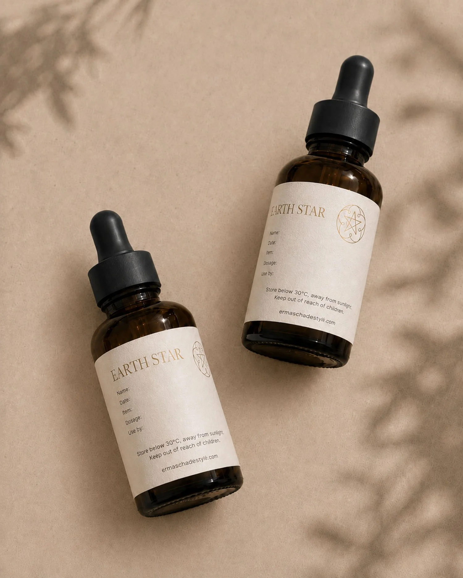 Custom gold foil label design for Emma Schade-Stylli shown on amber glass dropper bottles