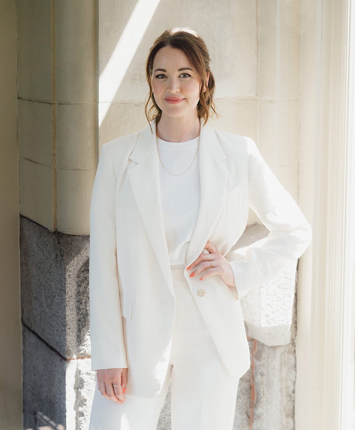 Jennifer Turner of Gemini Copy Co in a white suit during her brand photoshoot