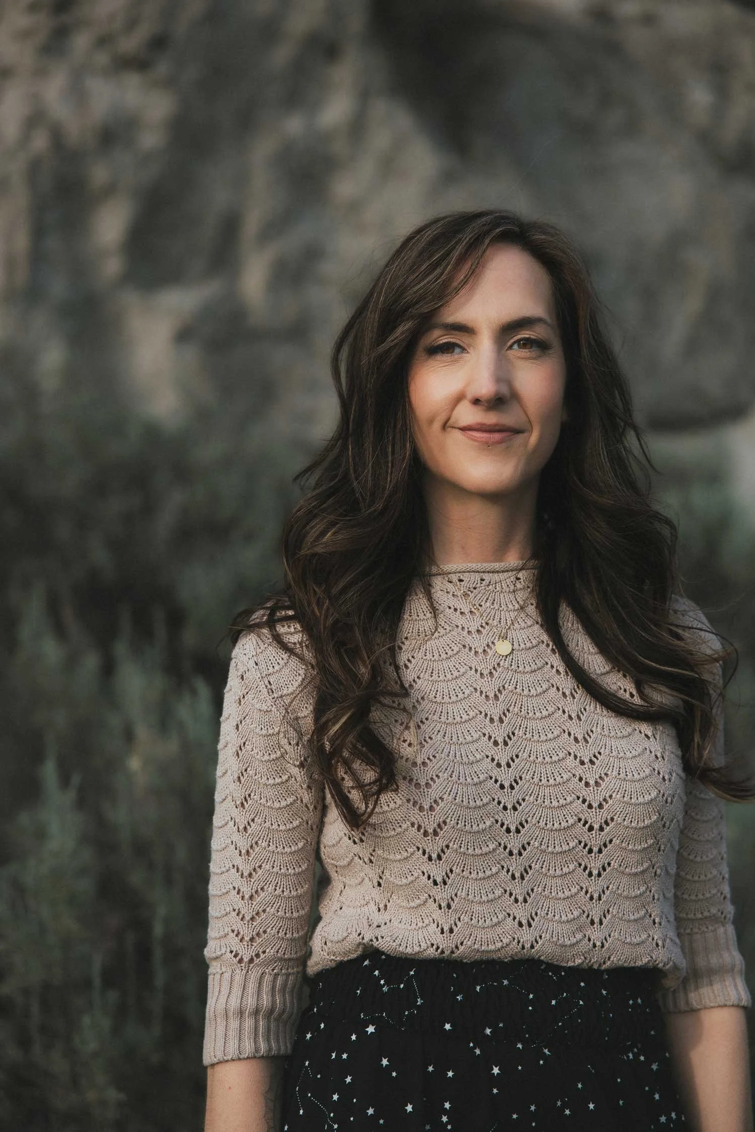 Miranda Braithwaite, founder of Moonstone Creative branding and web design studio, outdoors in the Okanagan Valley British Columbia among desert sage in a constellation skirt