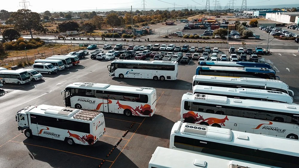 coaches in malaga depot with cars in the background