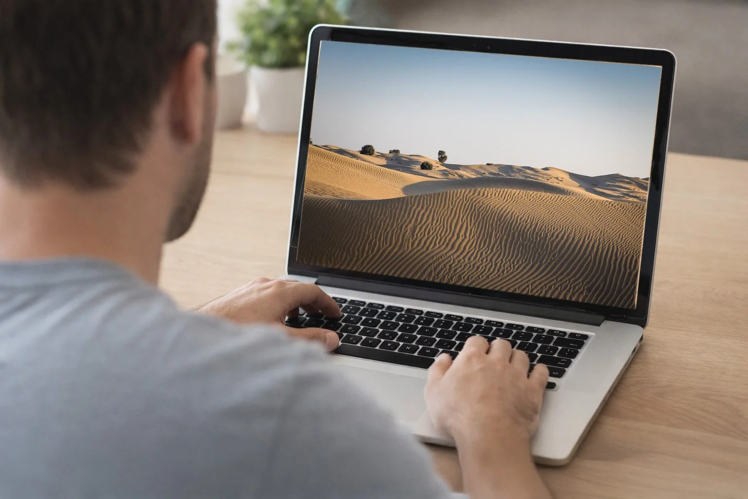 moc cave Man viewing owl photograph on laptop copy.jpg