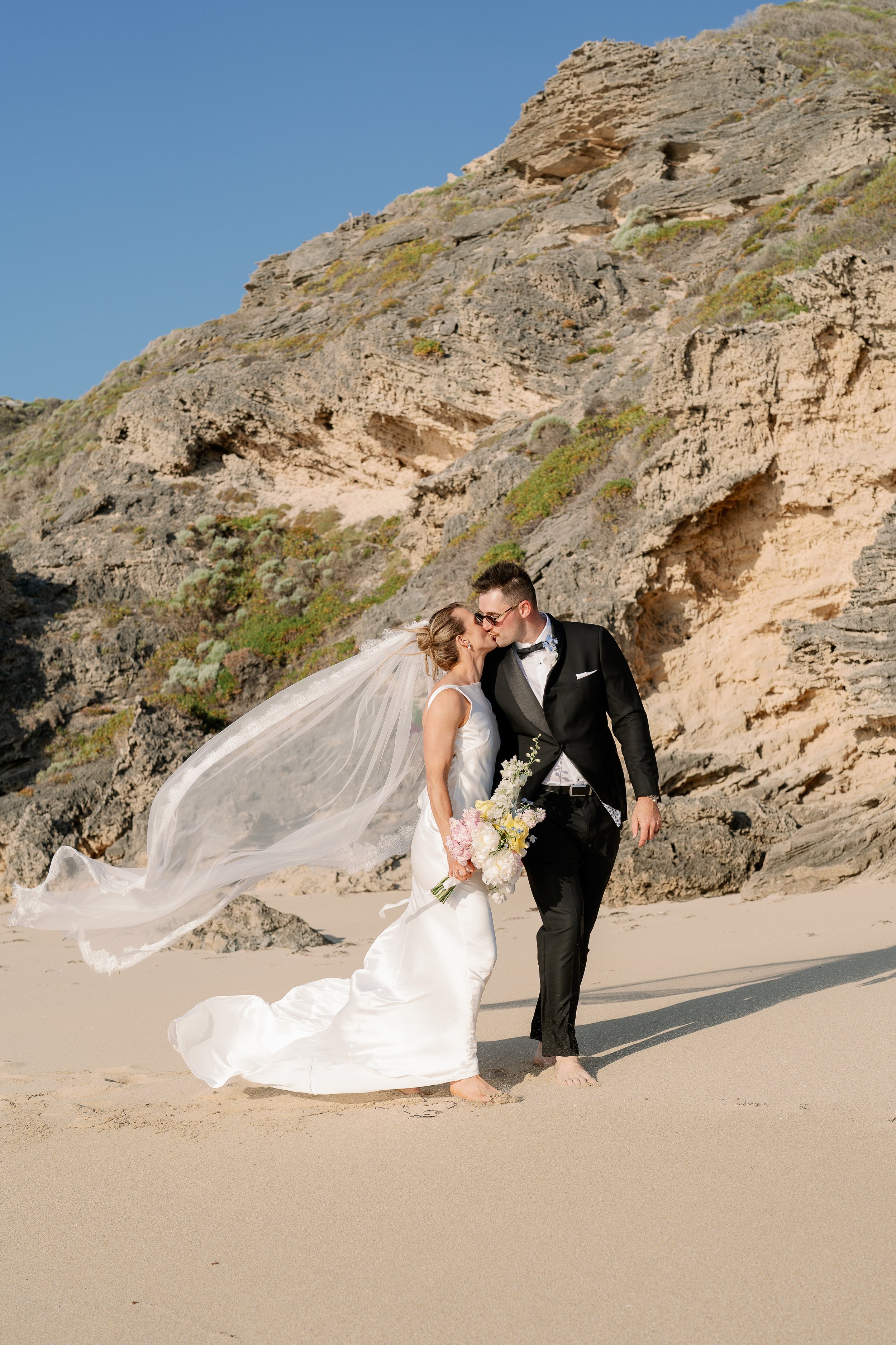 Relaxed wedding portraits on a private beach, after their ceremony at Hay Shed Hill Wines in the south west of Australia. Captured by Perth wedding photographer, who also services the south west, Natalie Jane.