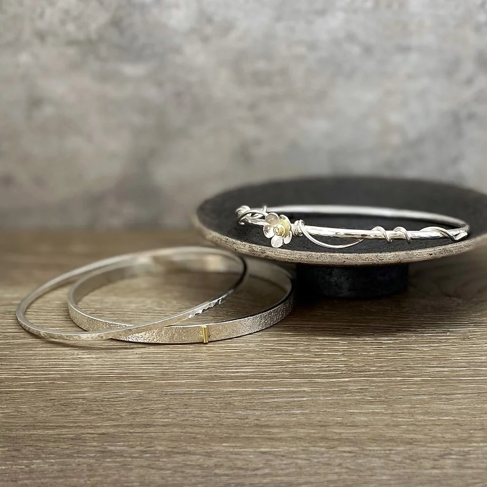 Three complementing silver bangles