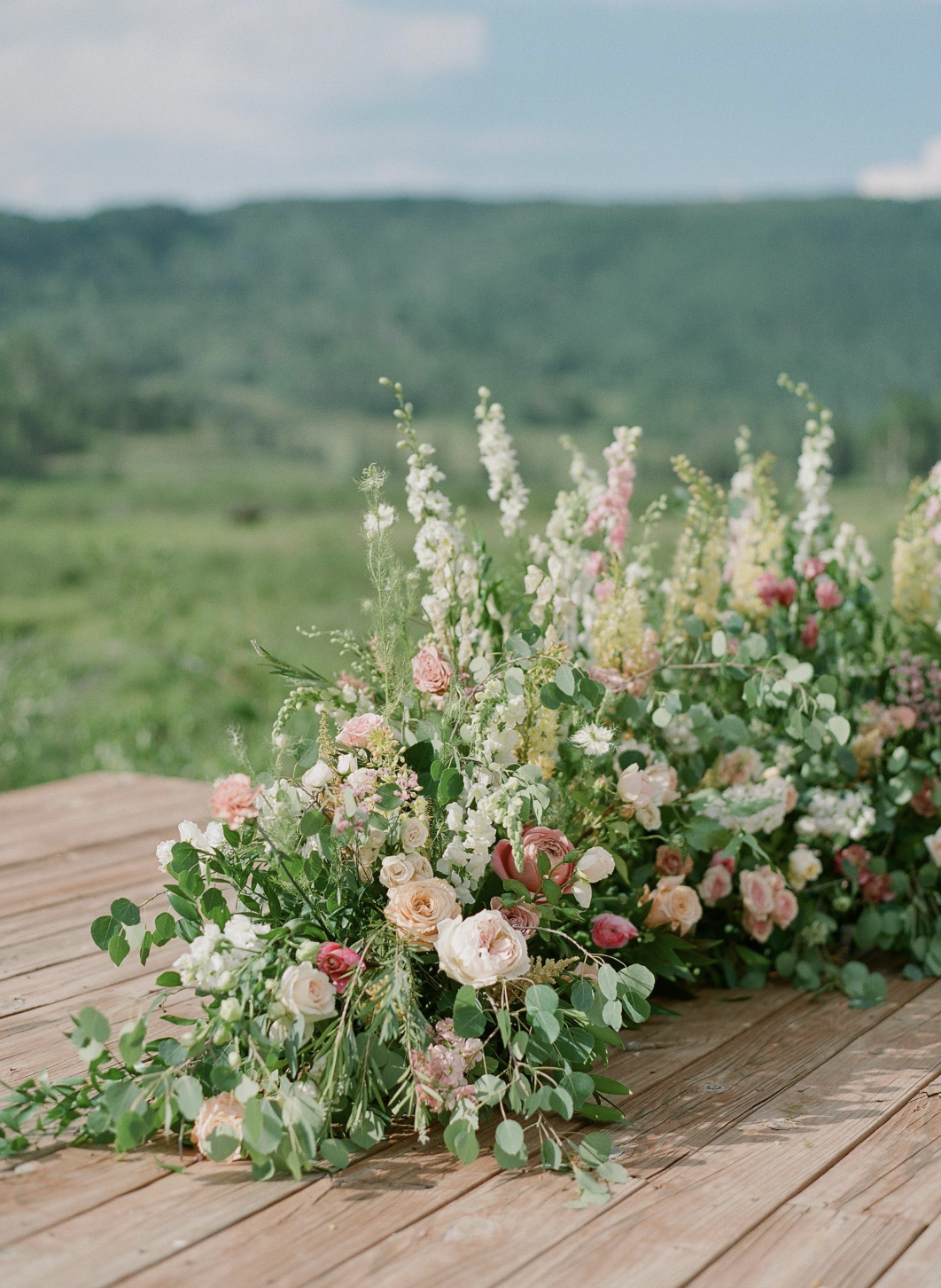  Wedding ceremony florals grounded meadow 