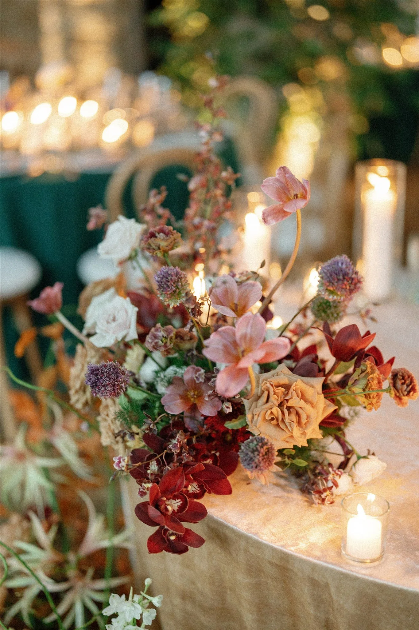  An autumn wedding centerpiece dripping with burgundy orchids. 