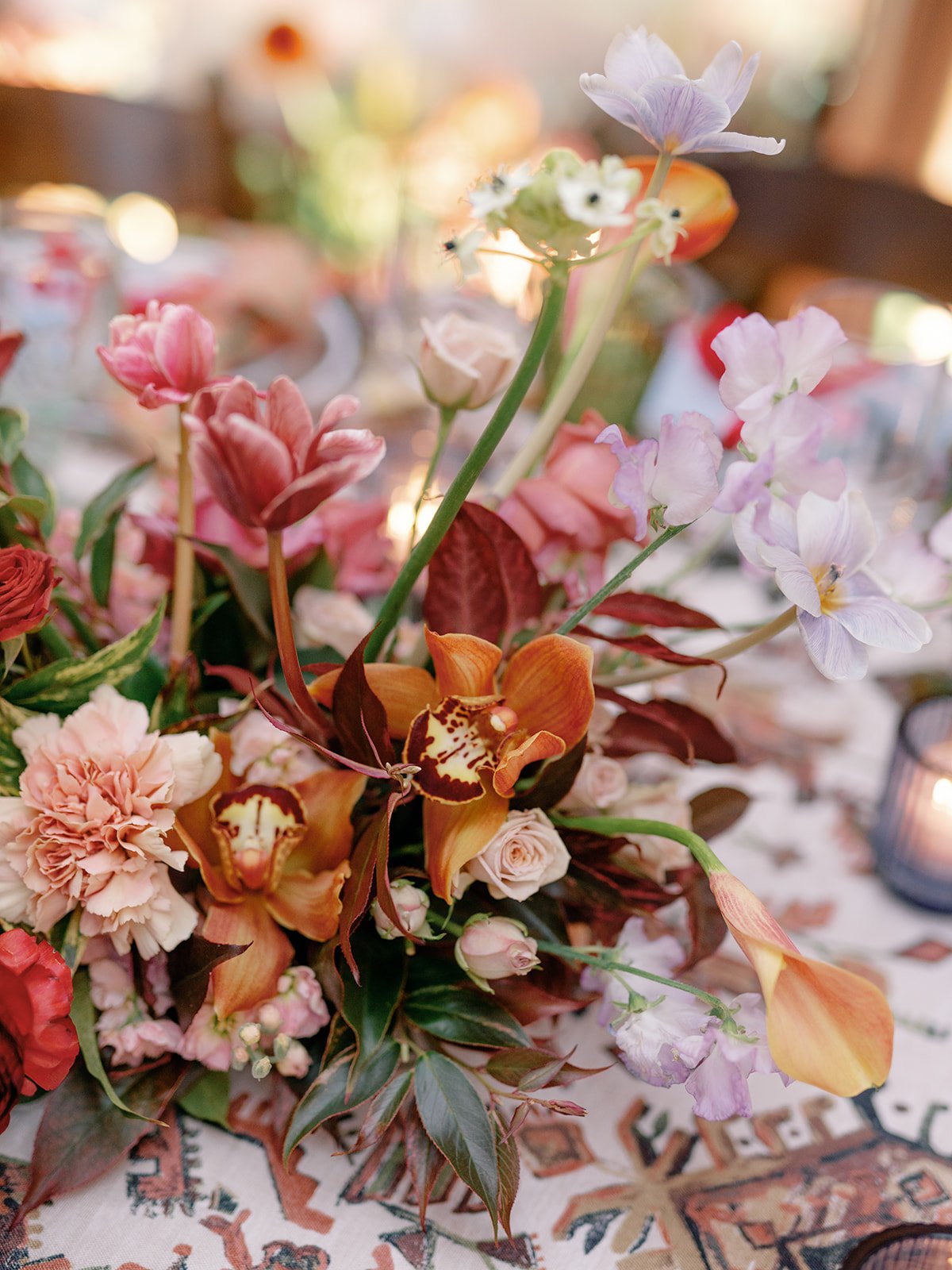  A lush floral centerpiece with orchids and more. 