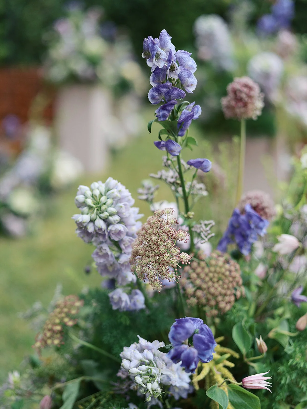 Detailed image of wedding florals at ceremony. 