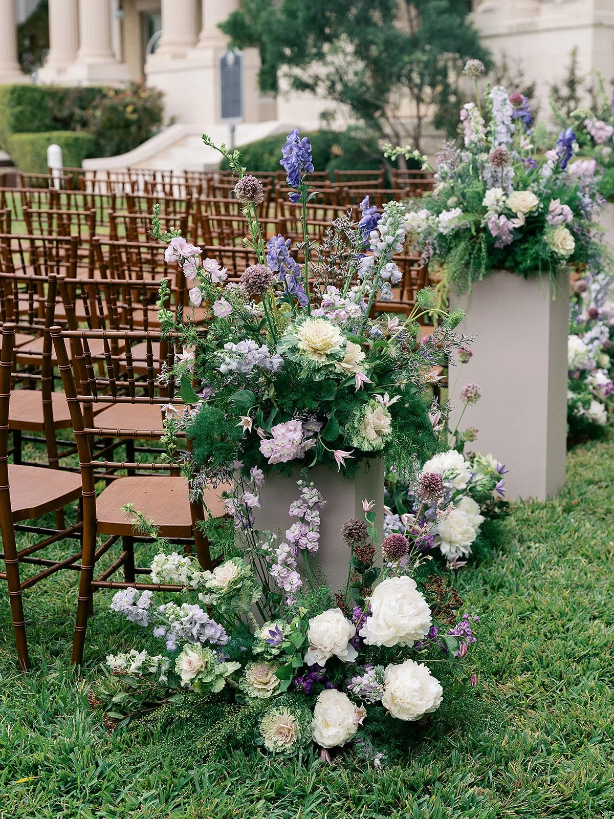  Layered purple aisle flowers on columns. 