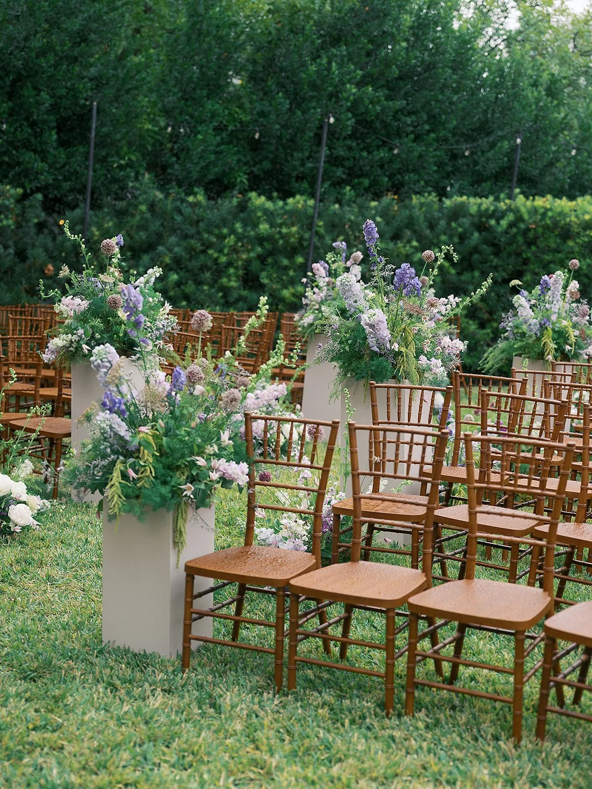  An outdoor wedding aisle with luxury wedding florals. 