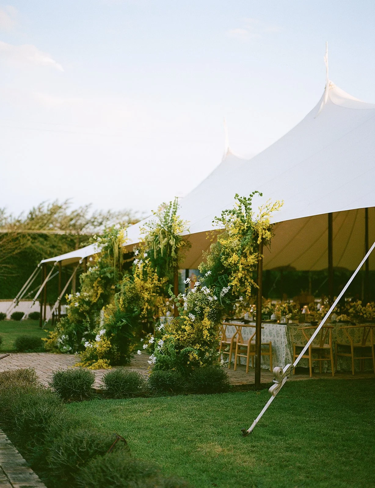  Yellow florals are the perfect way to perk up your wedding tent entrance. 